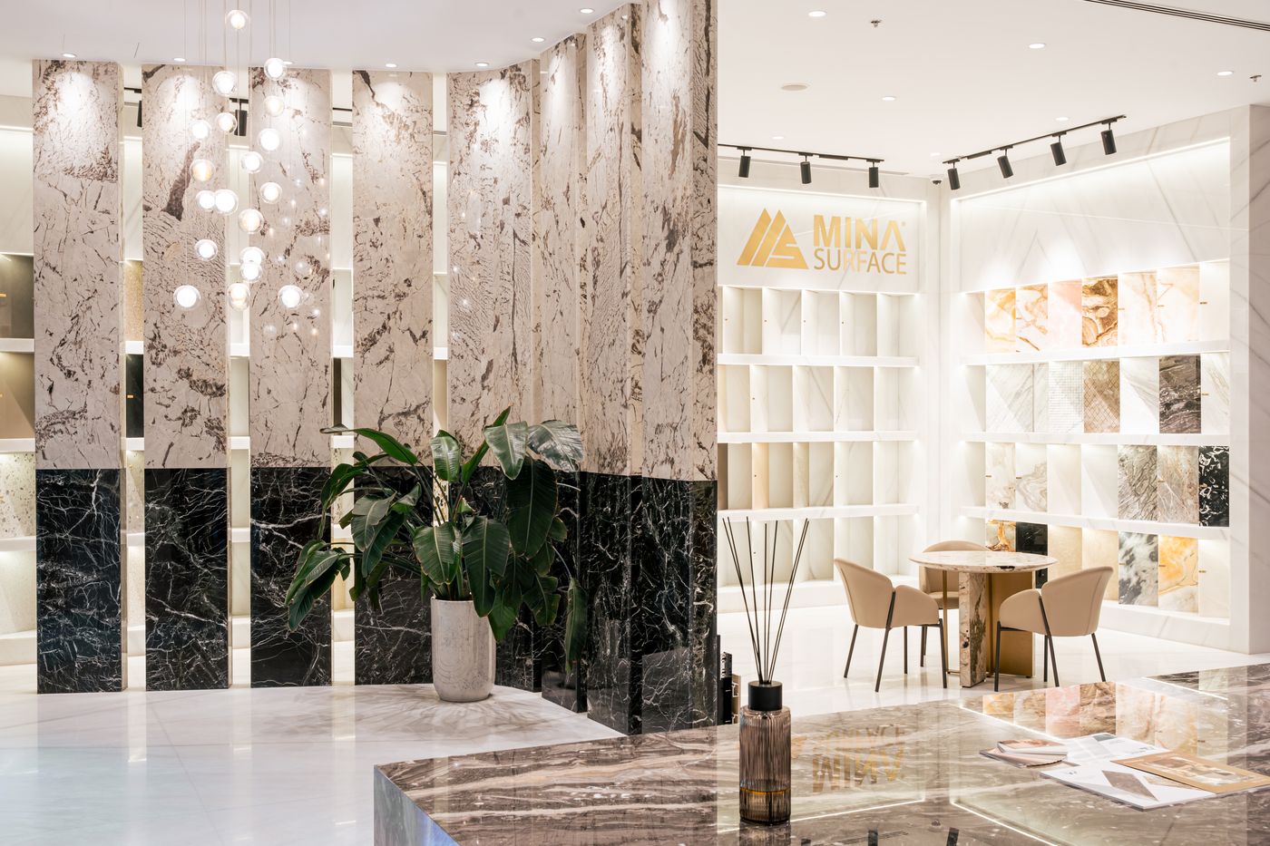 Gallery foyer with a dark marble feature wall and terrazzo sample displays