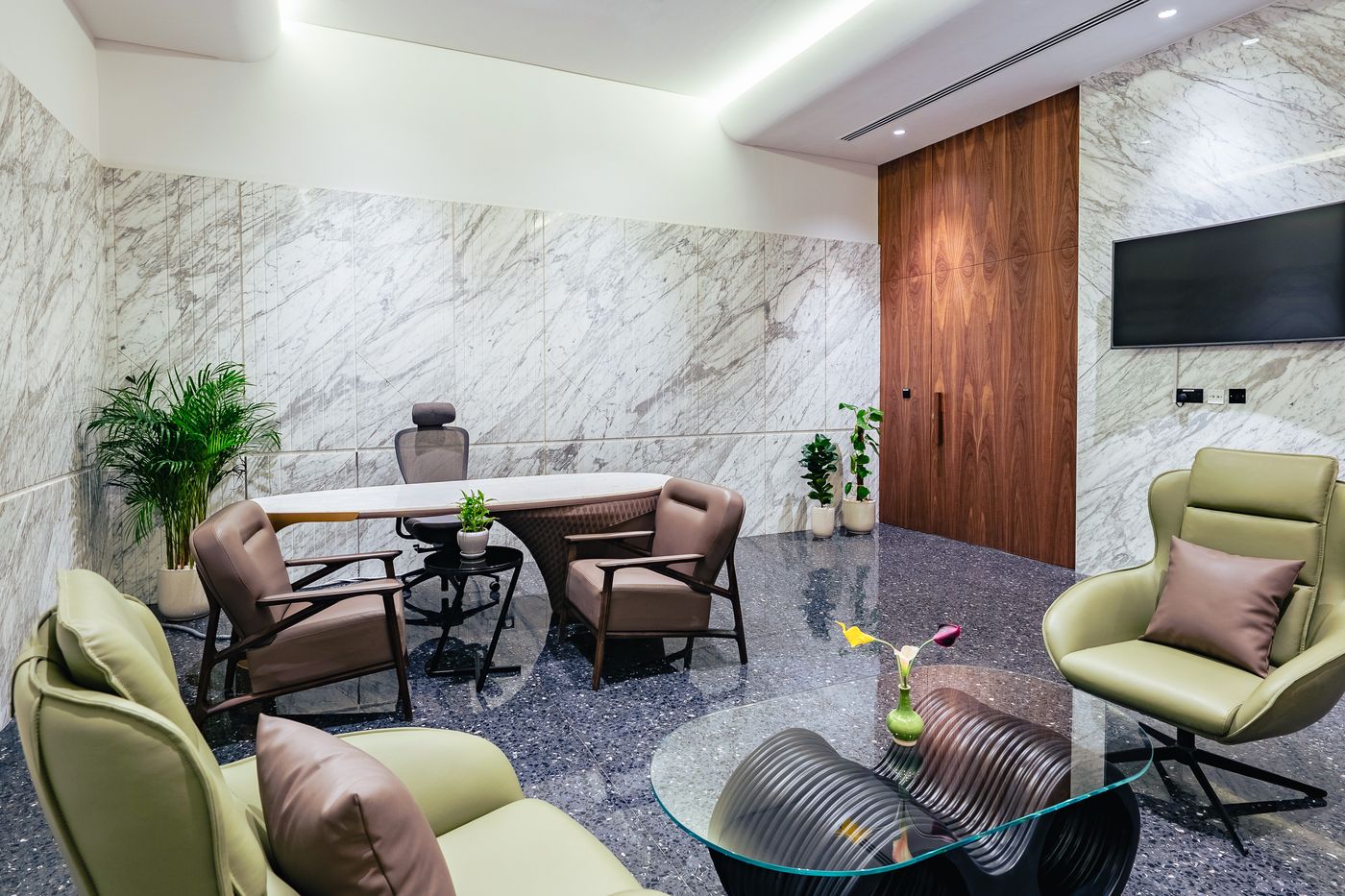 Lounge seating over a terrazzo floor with a marble feature wall
