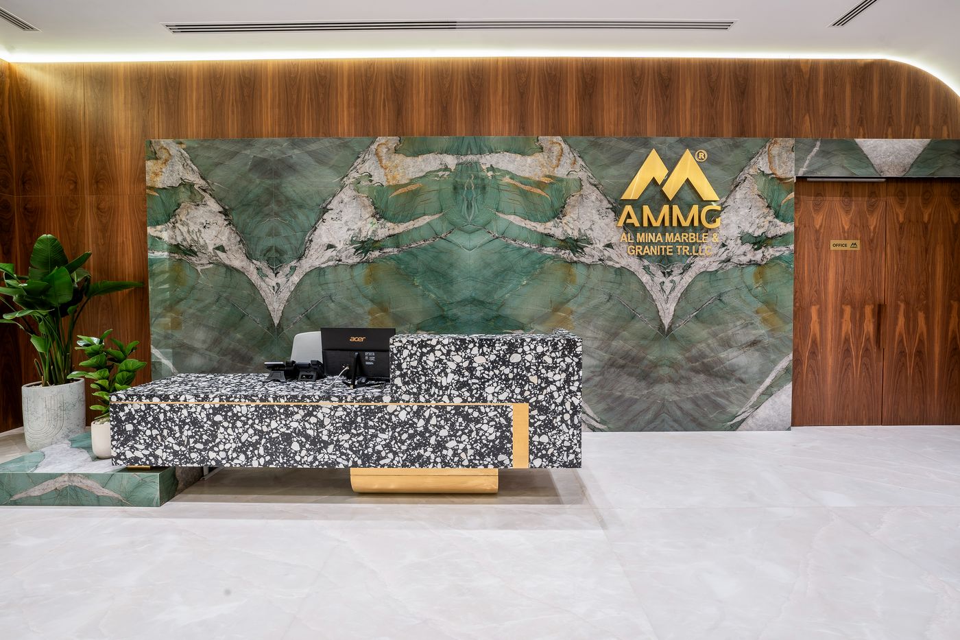Reception desk clad in book-matched green marble at the Mina Surface gallery, Sharjah