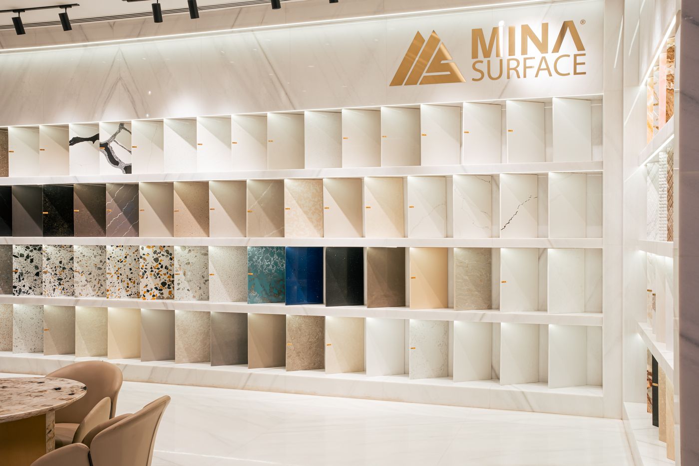 Full sample wall of quartz, engineered marble and terrazzo finishes under the Mina Surface logo