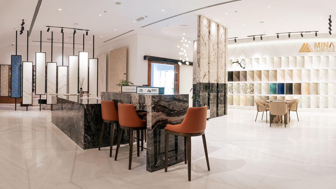 Main showroom hall with sample walls, a stone bar counter and seating