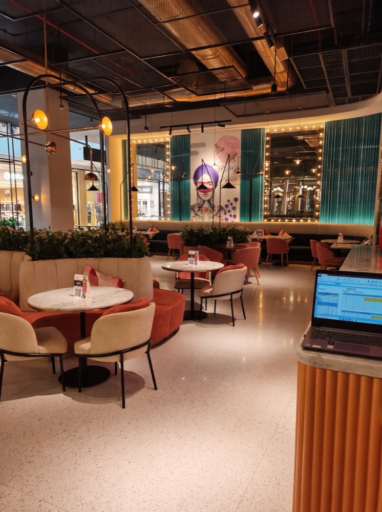 Terrazzo restaurant flooring and marble-topped tables at Falla, Al Zahia Mall, Sharjah — supplied by Mina Surface
