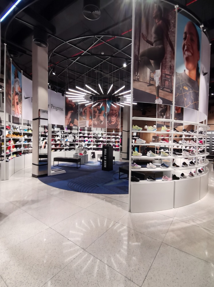 Speckled terrazzo retail flooring through the Nike store at Mall of the Emirates, Dubai — supplied by Mina Surface